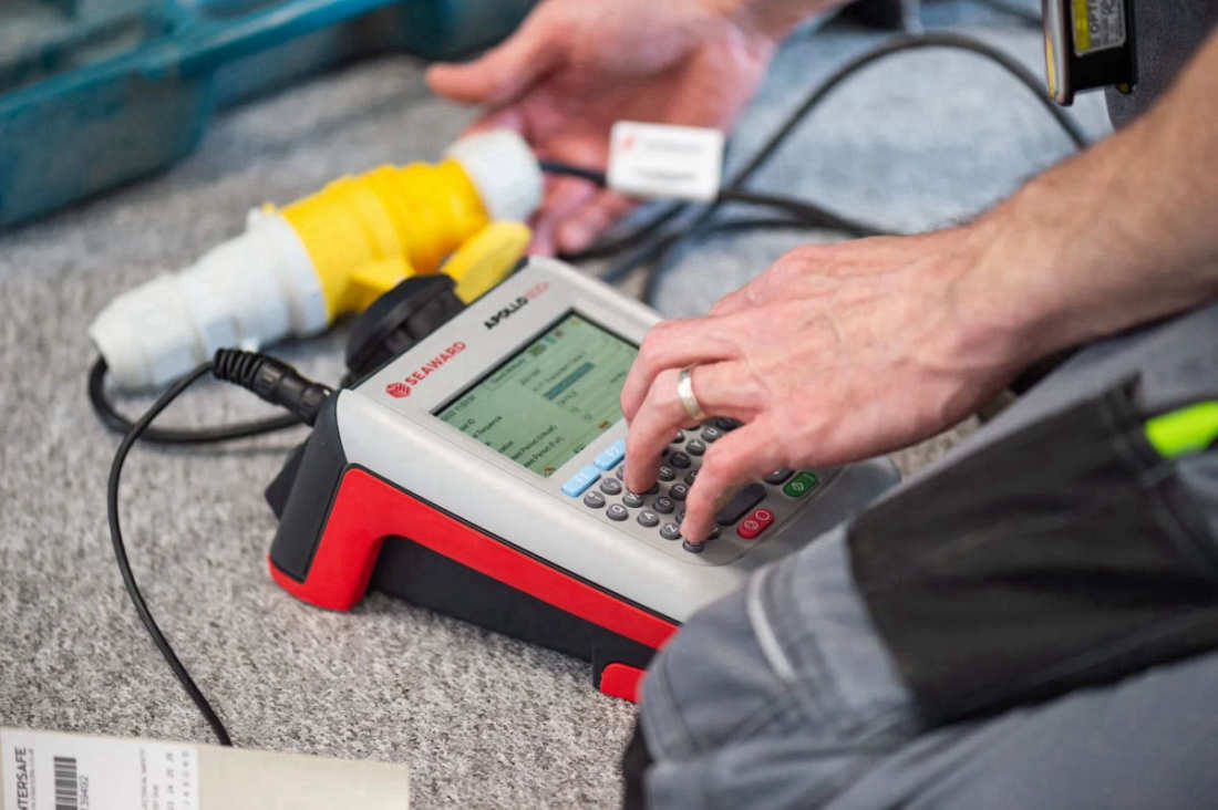 Seaward Apollo PAT tester connected to portable appliance test leads